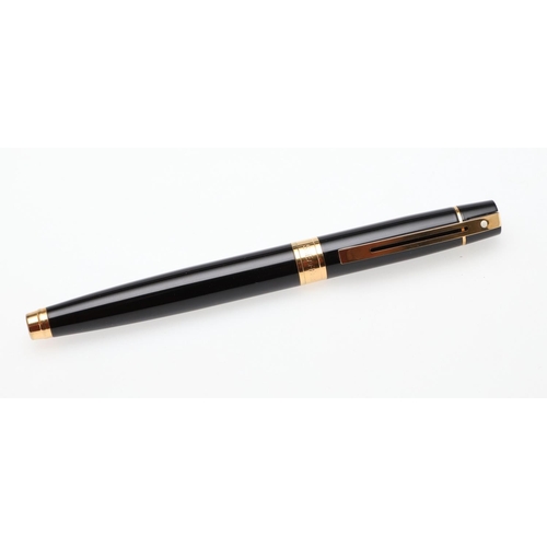 1528 - A SHEAFFER TARGA FOUNTAIN PEN. the red case with gold tone trim and white dot to cap, 14k nib; and a... 