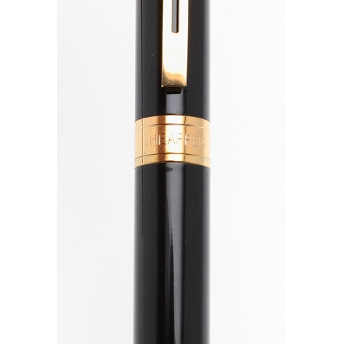 1528 - A SHEAFFER TARGA FOUNTAIN PEN. the red case with gold tone trim and white dot to cap, 14k nib; and a... 