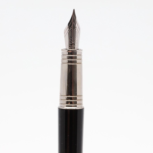 1530 - A PARKER PREMIER BLACK FOUNTAIN PEN. with black lacquer barrel and cap with chrome trim, the nib sta... 