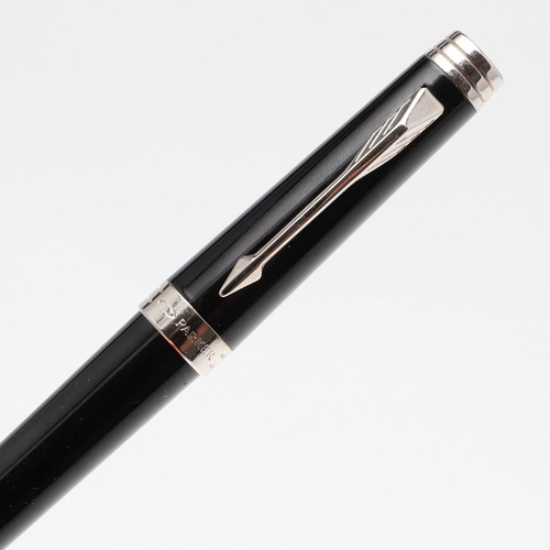 1530 - A PARKER PREMIER BLACK FOUNTAIN PEN. with black lacquer barrel and cap with chrome trim, the nib sta... 