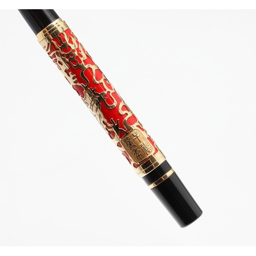 1542 - JINHAO: TWO FOUNTAIN PENS. model 5000, each decorated with gold coloured metal dragon overlay to red... 