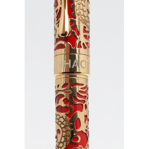 1542 - JINHAO: TWO FOUNTAIN PENS. model 5000, each decorated with gold coloured metal dragon overlay to red... 