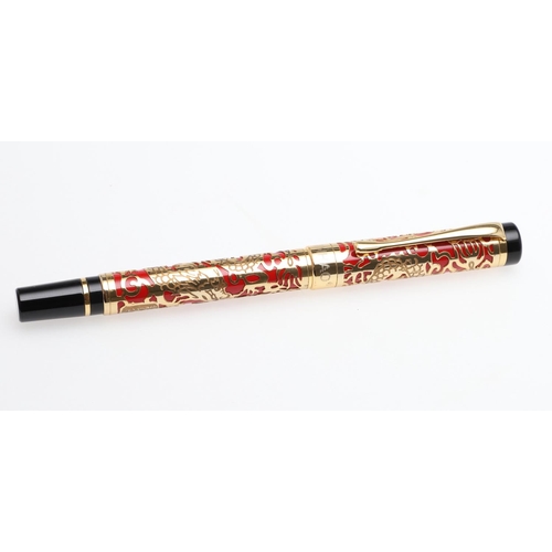 1542 - JINHAO: TWO FOUNTAIN PENS. model 5000, each decorated with gold coloured metal dragon overlay to red... 