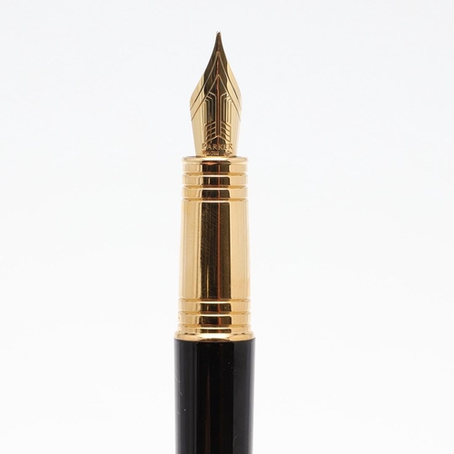 1545 - A PARKER PREMIER BLACK FOUNTAIN PEN. with black lacquer barrel and cap, gilt trim and 18k gold nib. ... 