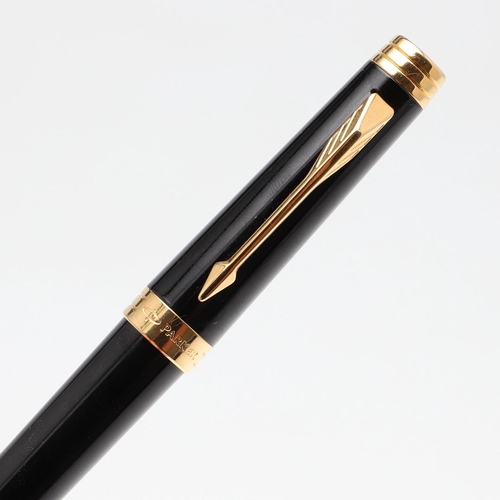 1545 - A PARKER PREMIER BLACK FOUNTAIN PEN. with black lacquer barrel and cap, gilt trim and 18k gold nib. ... 