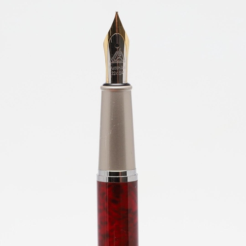 1549 - ASSORTED FOUNTAIN PENS. comprising a Huashilai pen with mottled red resin body and brushed steel cap... 