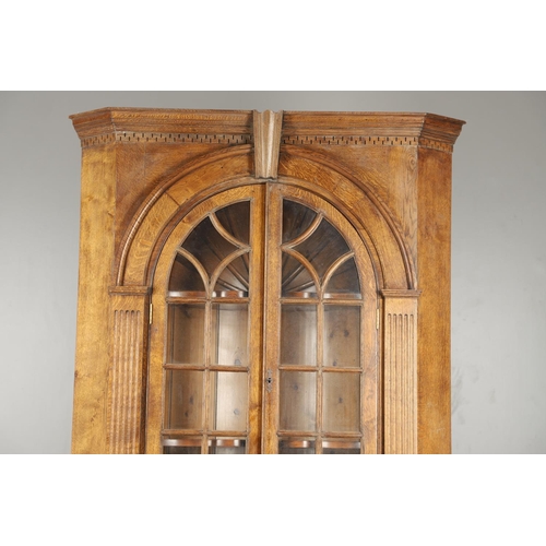 1556 - AN OAK BARREL BACK ALCOVE CUPBOARD. the upper half with Classical architectural features to three sh... 