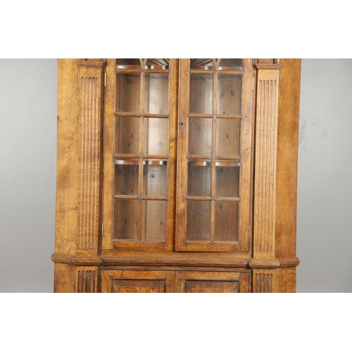 1556 - AN OAK BARREL BACK ALCOVE CUPBOARD. the upper half with Classical architectural features to three sh... 