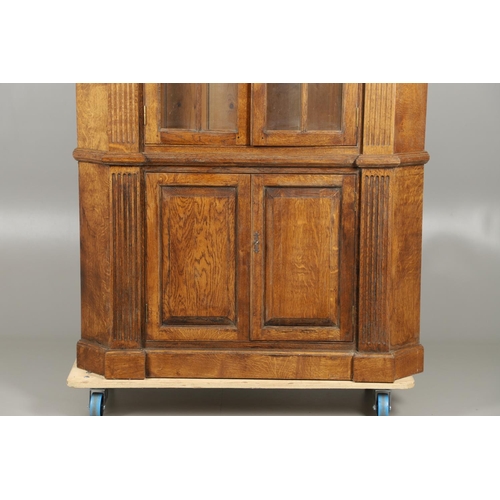 1556 - AN OAK BARREL BACK ALCOVE CUPBOARD. the upper half with Classical architectural features to three sh... 