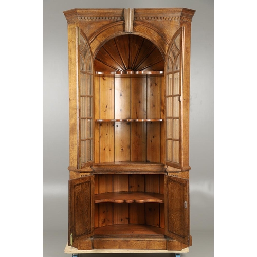 1556 - AN OAK BARREL BACK ALCOVE CUPBOARD. the upper half with Classical architectural features to three sh... 