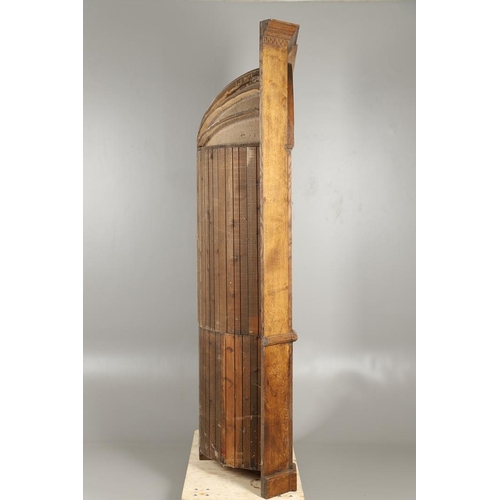 1556 - AN OAK BARREL BACK ALCOVE CUPBOARD. the upper half with Classical architectural features to three sh... 