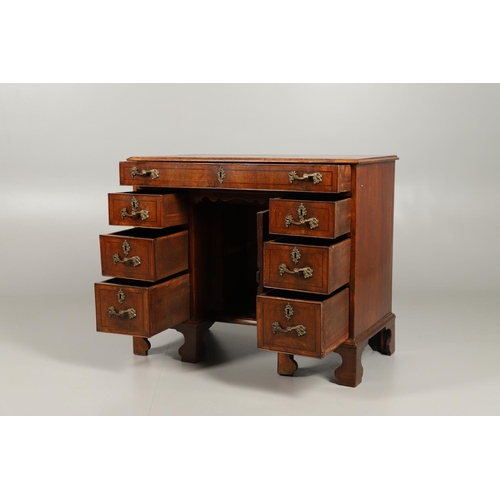 1560 - A GEORGE III WALNUT KNEEHOLE DESK. the top inset with gilt tooled green leather over a long drawer a... 