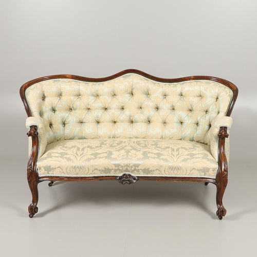 1568 - A ROSEWOOD SHOW FRAME BUTTON BACK TWO SEATER SOFA. 19th century, the wavy frame on carved scroll arm... 