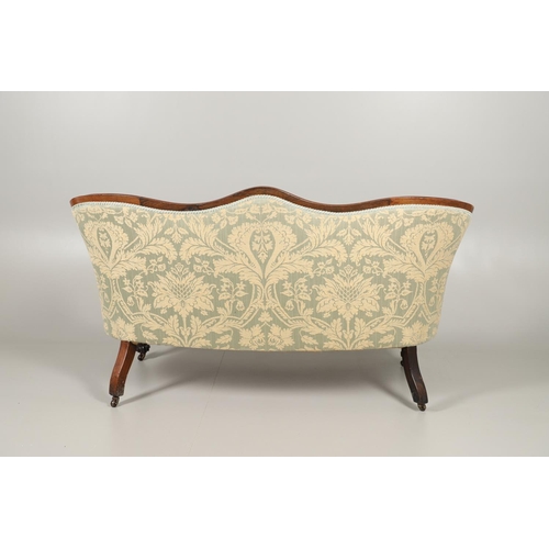 1568 - A ROSEWOOD SHOW FRAME BUTTON BACK TWO SEATER SOFA. 19th century, the wavy frame on carved scroll arm... 