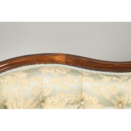 1568 - A ROSEWOOD SHOW FRAME BUTTON BACK TWO SEATER SOFA. 19th century, the wavy frame on carved scroll arm... 