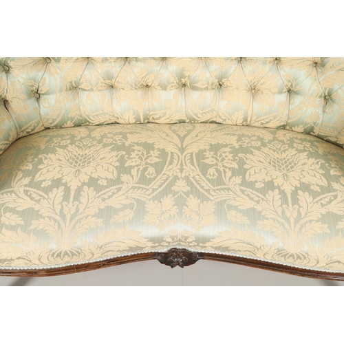 1568 - A ROSEWOOD SHOW FRAME BUTTON BACK TWO SEATER SOFA. 19th century, the wavy frame on carved scroll arm... 