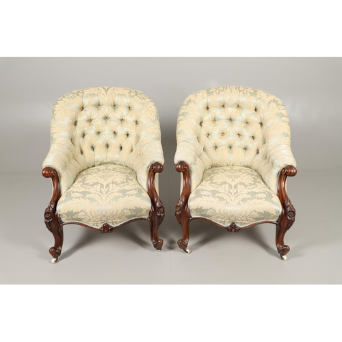 1569 - A PAIR OF MAHOGANY SHOW FRAME BUTTON BACK ARMCHAIRS. 19th century, the scroll and flower carved fram... 