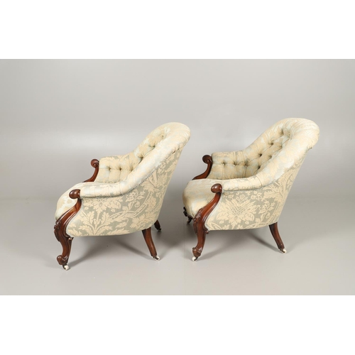 1569 - A PAIR OF MAHOGANY SHOW FRAME BUTTON BACK ARMCHAIRS. 19th century, the scroll and flower carved fram... 