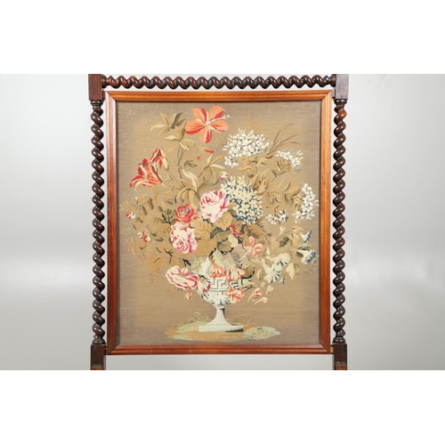 1581 - A 19TH CENTURY ROSEWOOD FIRESCREEN. the glazed needlework panel depicting a flowering urn on a barle... 