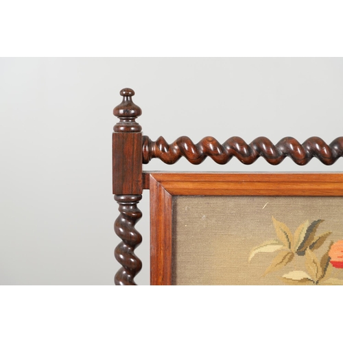 1581 - A 19TH CENTURY ROSEWOOD FIRESCREEN. the glazed needlework panel depicting a flowering urn on a barle... 