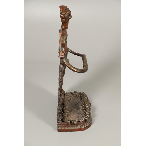 1595 - A PAINTED CAST IRON UMBRELLA/STICK STAND. 19th century, modelled as a semi-clad boy fighting a snake... 