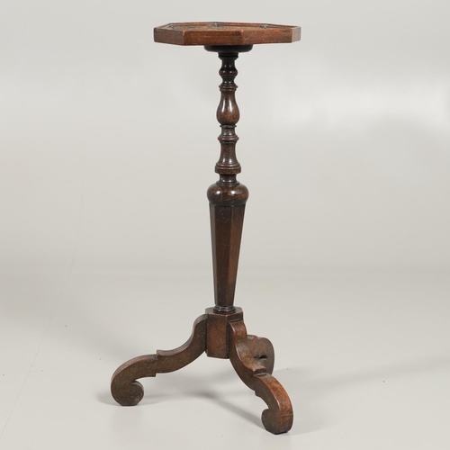 1600 - AN 18TH CENTURY WALNUT CANDLESTAND. the octagonal top upon a turned column and scrolling swept tripo... 