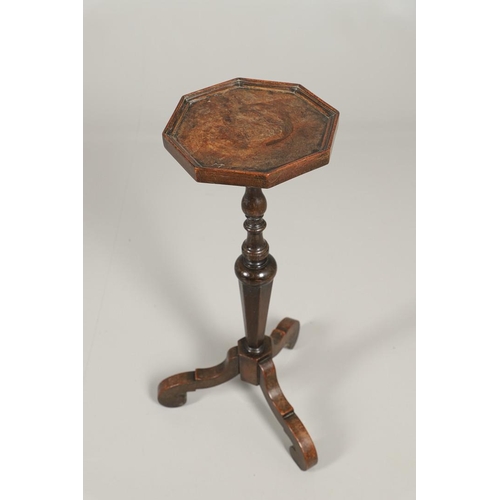 1600 - AN 18TH CENTURY WALNUT CANDLESTAND. the octagonal top upon a turned column and scrolling swept tripo... 