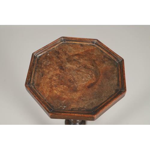 1600 - AN 18TH CENTURY WALNUT CANDLESTAND. the octagonal top upon a turned column and scrolling swept tripo... 