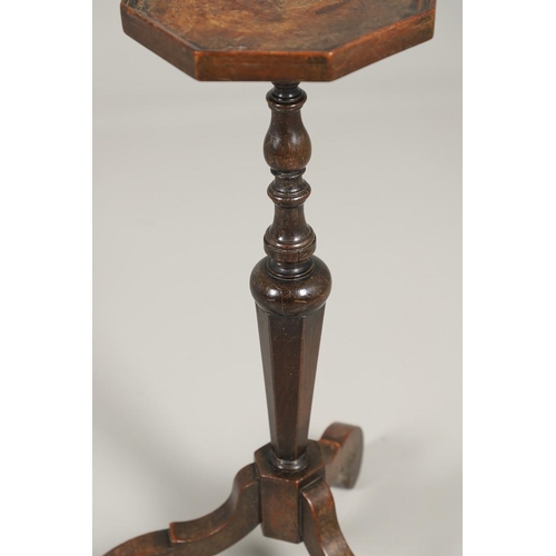 1600 - AN 18TH CENTURY WALNUT CANDLESTAND. the octagonal top upon a turned column and scrolling swept tripo... 