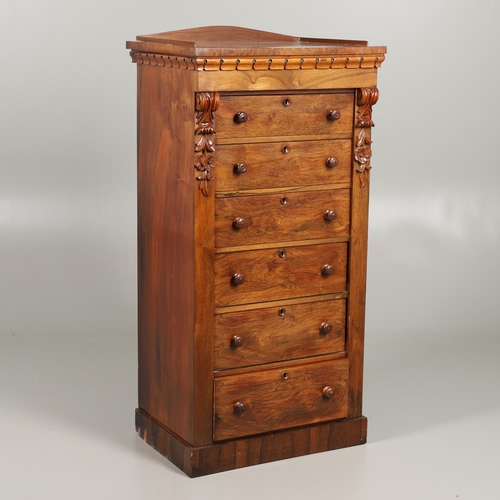 1601 - A VICTORIAN ROSEWOOD WELLINGTON STYLE CHEST. the six drawers with carved scroll and flower corbels o... 