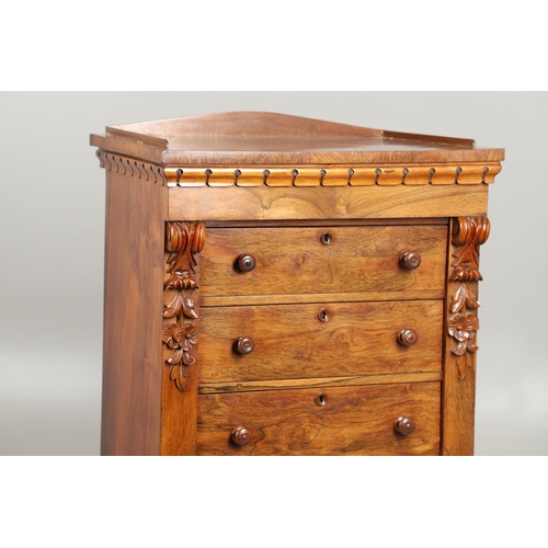 1601 - A VICTORIAN ROSEWOOD WELLINGTON STYLE CHEST. the six drawers with carved scroll and flower corbels o... 