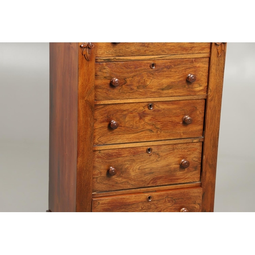 1601 - A VICTORIAN ROSEWOOD WELLINGTON STYLE CHEST. the six drawers with carved scroll and flower corbels o... 