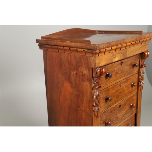 1601 - A VICTORIAN ROSEWOOD WELLINGTON STYLE CHEST. the six drawers with carved scroll and flower corbels o... 