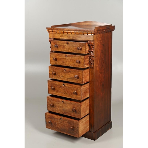 1601 - A VICTORIAN ROSEWOOD WELLINGTON STYLE CHEST. the six drawers with carved scroll and flower corbels o... 