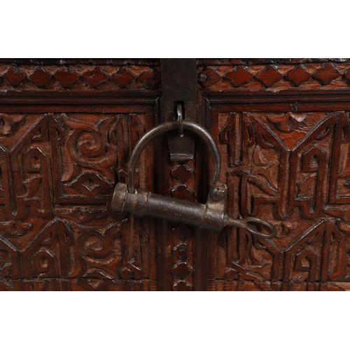 1604 - A LARGE 19TH CENTURY CARVED ISLAMIC COFFER. panelled and carved on all sides with symbols and motifs... 