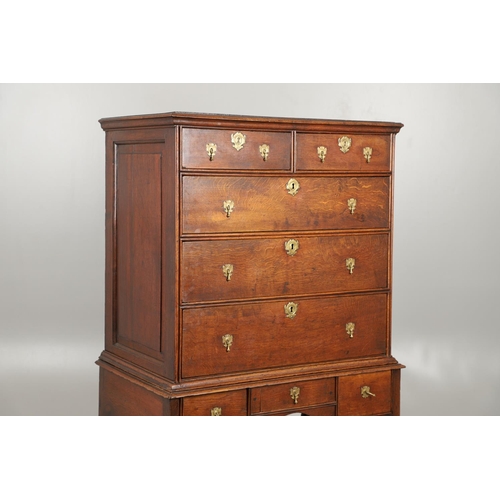 1605 - AN EARLY 18TH CENTURY OAK CHEST ON STAND. the moulded cornice over panelled sides, two short and thr... 