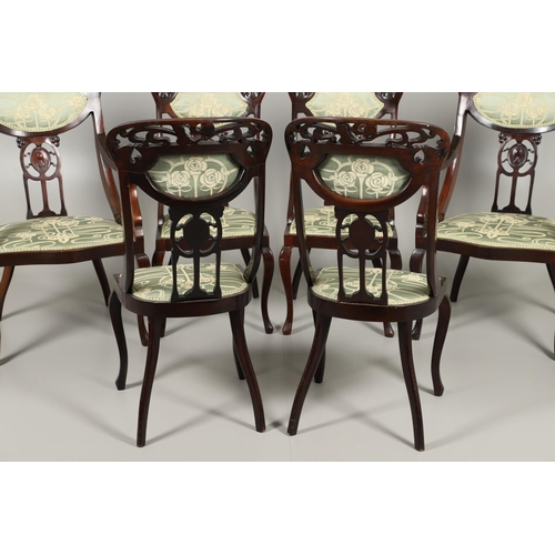 1609 - A SET OF SIX ART NOUVEAU MAHOGANY DINING CHAIRS. circa 1900, the backs pierced and carved with fruit... 