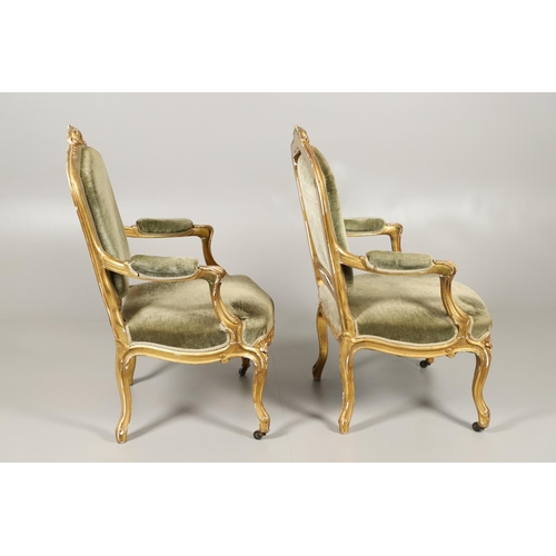 1610 - A PAIR OF 19TH CENTURY LOUIS XV STYLE GILTWOOD FAUTEUILS A LA REINES. each with a carved show frame ... 