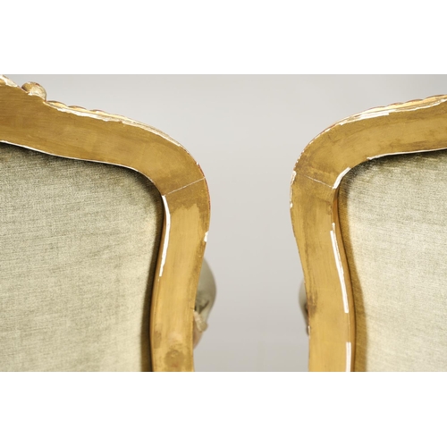 1610 - A PAIR OF 19TH CENTURY LOUIS XV STYLE GILTWOOD FAUTEUILS A LA REINES. each with a carved show frame ... 