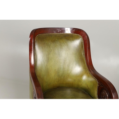 1612 - A 19TH CENTURY GREEN LEATHER MAHOGANY LIBRARY ARMCHAIR. the scrolling arm supports with carved flora... 