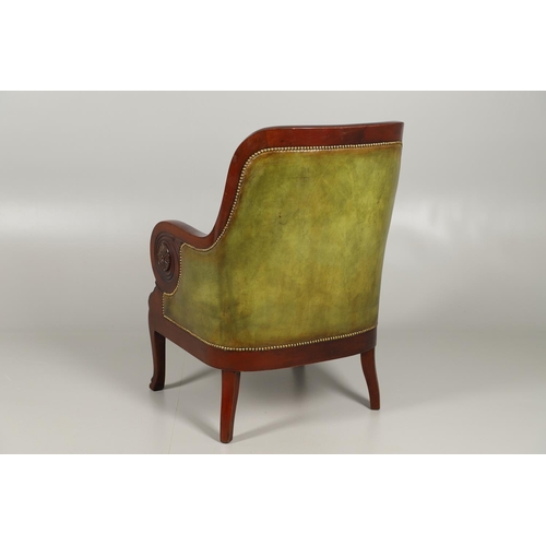 1612 - A 19TH CENTURY GREEN LEATHER MAHOGANY LIBRARY ARMCHAIR. the scrolling arm supports with carved flora... 