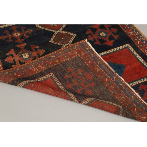 1734 - A KAZAK RUG, CENTRAL CAUCASUS, CIRCA 1910. the indigo field with two terracotta cruciform medallions... 