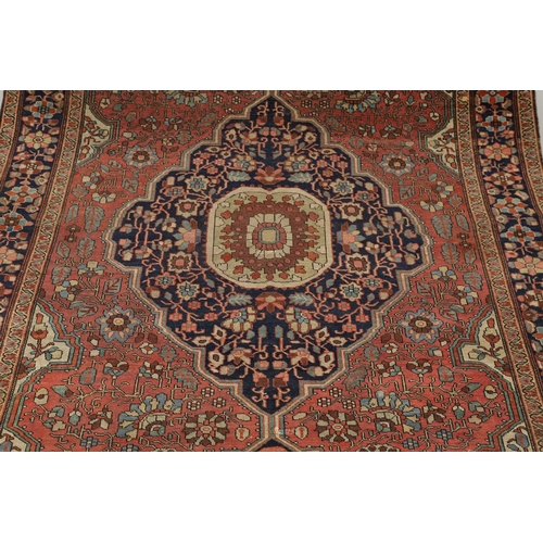 1735 - A SAROUK RUG, WEST PERSIA, CIRCA 1930. the brick red field of angular vines around an ivory and indi... 