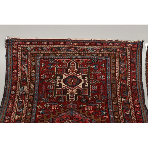 1738 - A KARAJA RUG, NORTH WEST PERSIA, CIRCA 1950. the claret field with three medallions enclosed by mult... 