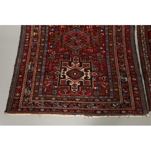 1738 - A KARAJA RUG, NORTH WEST PERSIA, CIRCA 1950. the claret field with three medallions enclosed by mult... 