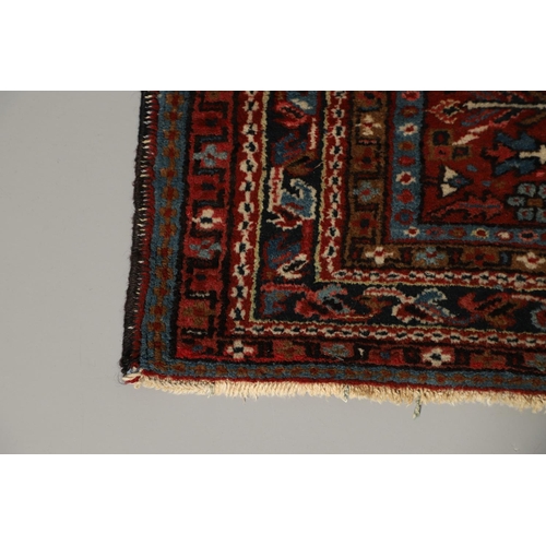 1738 - A KARAJA RUG, NORTH WEST PERSIA, CIRCA 1950. the claret field with three medallions enclosed by mult... 