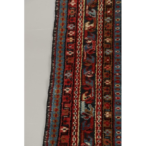 1738 - A KARAJA RUG, NORTH WEST PERSIA, CIRCA 1950. the claret field with three medallions enclosed by mult... 