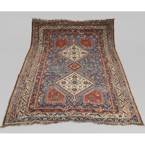 1741 - A KASHGAI RUG, SOUTH WEST PERSIA, CIRCA 1940. the indigo field with three diamond medallions framed ... 