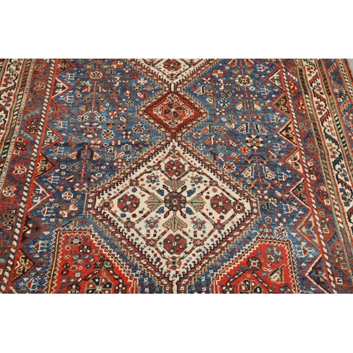 1741 - A KASHGAI RUG, SOUTH WEST PERSIA, CIRCA 1940. the indigo field with three diamond medallions framed ... 