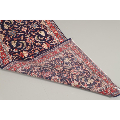 1743 - A NARROW PERSIAN RUNNER, PROBABLY SAROUKH, CIRCA 1970. the indigo field of scrolling vines and palme... 